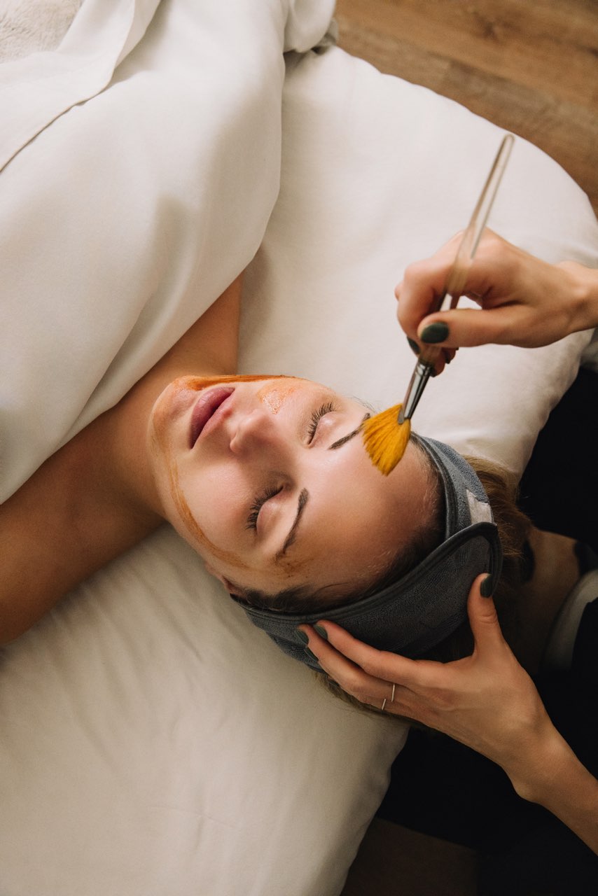 Esthetician applying a chemical peel at River & Pearl Beauty Bar